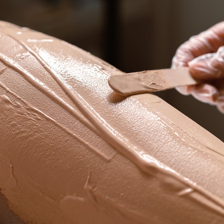 Hard wax being applied with a spatula