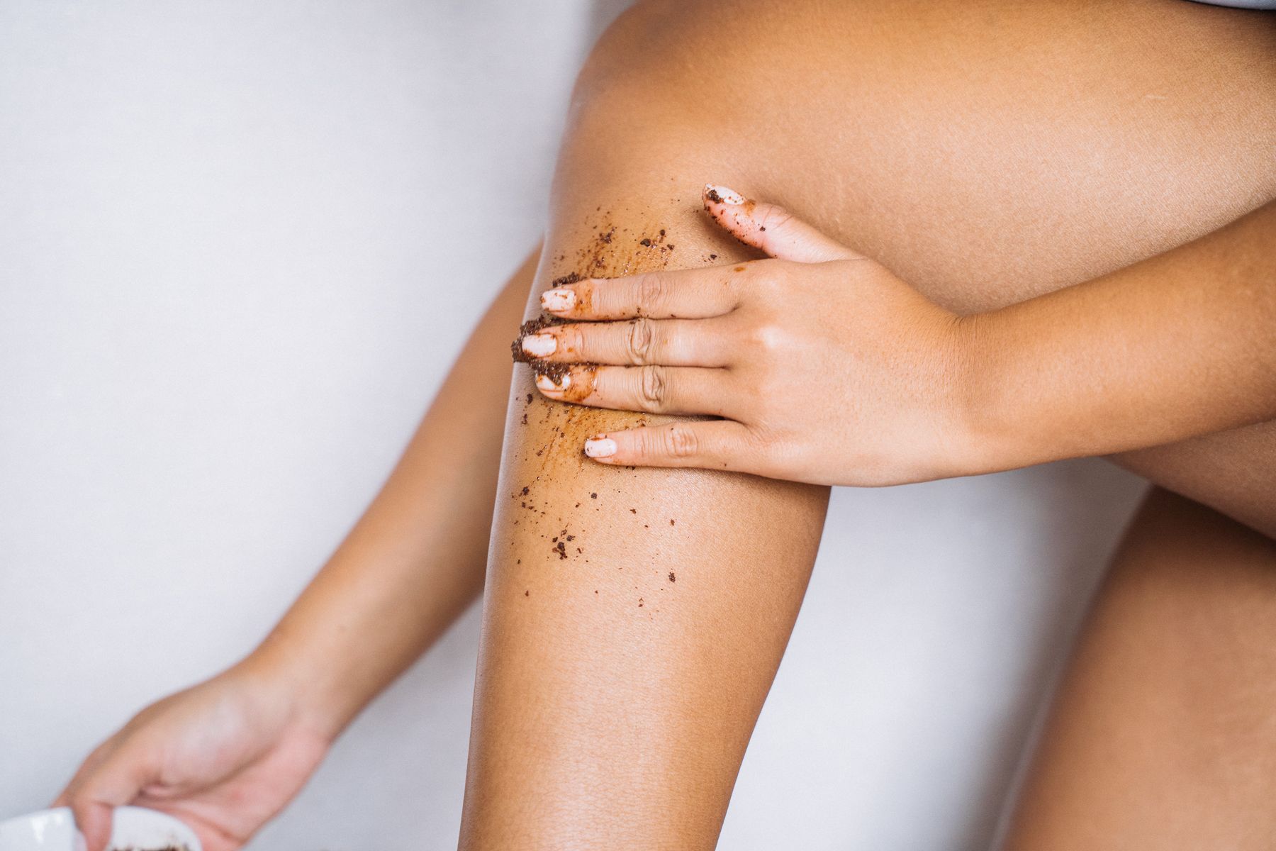 Exfoliating scrub massaged into the leg before waxing